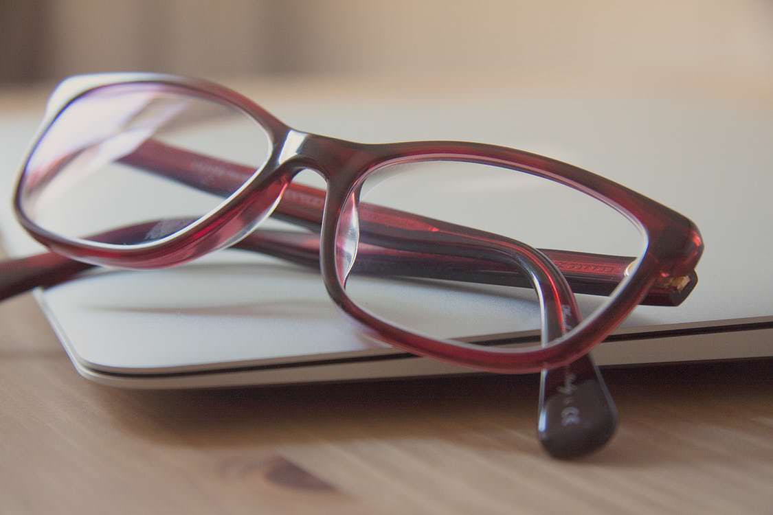 A pair of glasses on the laptop of an optometrist who uses OD Link.